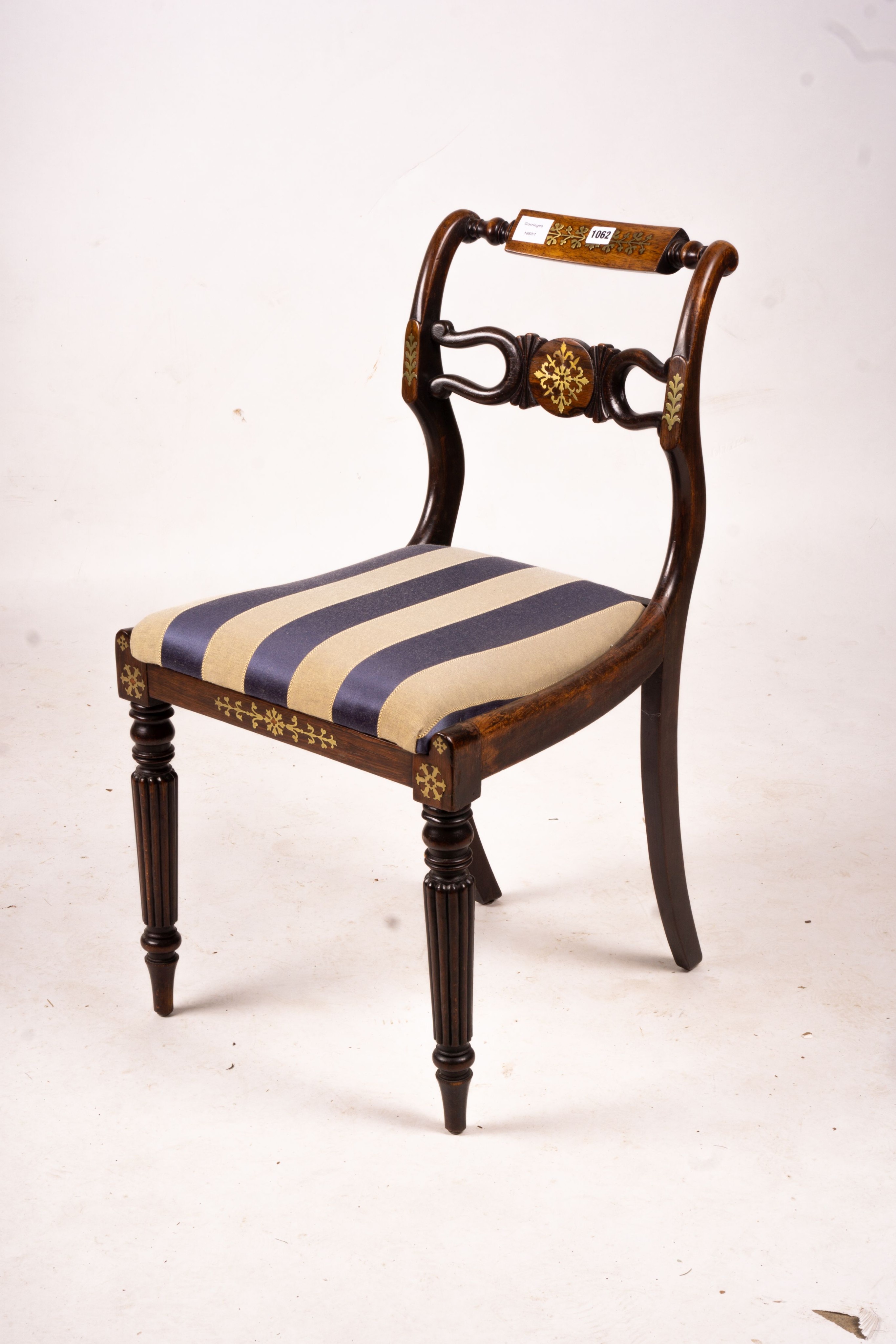 A set of six Regency brass inset simulated rosewood dining chairs